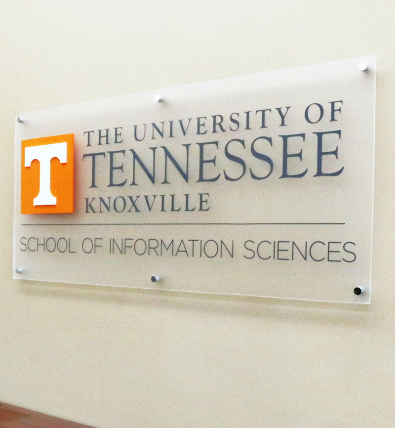 A photo of the School of Information Sciences sign on a wall